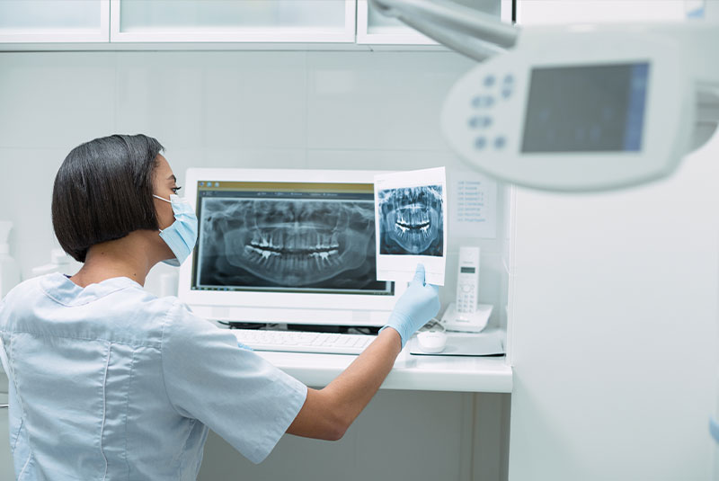 dentist figuring out dental implant treatment