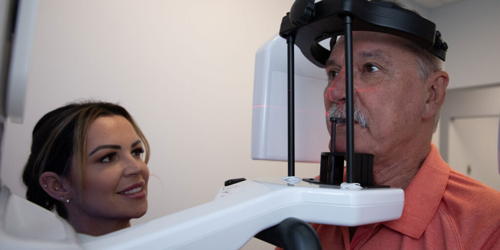 Patient with 3D scanning device for dental procedure within the dental practice