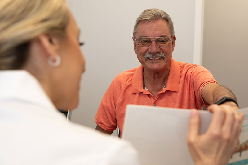 Patient and doctor going over information at patients consultation within the dental practice